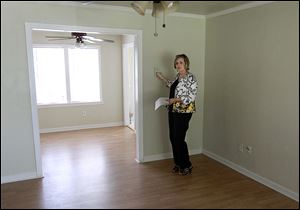 Agent Kimi George shows a new home for sale in The Village, Okla. Potential buyers are advised to picture their belongings in a house and imagine how the spaces will work for them.