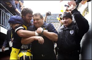 Michigan defensive end Craig Roh hugs coach Brady Hoke. Roh, a fifth-year senior, has seen his share of turmoil and celebration. The UM senior class has gone 33-27 overall, 17-21 in the Big Ten with two different coaches at the helm.