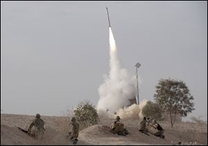 An Israeli Iron Dome missile is launched near the city of Be'er Sheva, southern Israel, to intercept a rocket fired from Gaza Saturday.