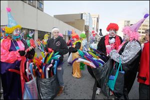 Distinguished Clown Corps member Marge McFadden, her niece Katie Hill, Bob Savage, and Susan Sterling before last year's holiday parade.