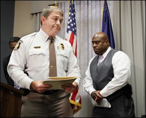 Sylvania Township police Chief Robert Boehme, left, and Toledo police Chief Derrick Diggs are grim after discussing the   carbon monoxide poisoning deaths. They addressed reporters Friday at the Safety Building in Toledo. 