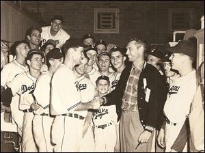 The 1948 Zanesville Dodgers celebrate their Ohio-Indiana League championship with batboy George Eistetter, center. Richard Meyers is the third player from the right, behind the head and left shoulder of the man in the jacket.