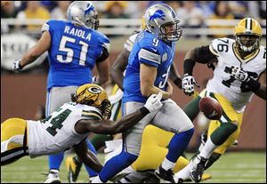 Green Bay Packers linebacker Dezman Moses, left, strips the ball away from Detroit Lions quarterback Matthew Stafford during the second quarter Sunday at Ford Field in Detroit. Green Bay recovered. Stafford went 17 of 39 for 266 yards with two interceptions, one of which was returned for a touchdown in the third quarter.