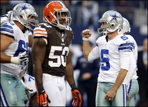 Cleveland Browns linebacker James-Michael Johnson, center, walks off as Dallas Cowboys tackle Doug Free, left, celebrates with Dan Bailey after Bailey kicked a game-winning 38-yard field goal in overtime Sunday in Arlington, Texas. The Browns lost 23-20.