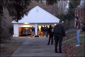 Authorities respond to a report of carbon monoxide poisoning last week on Harvest Lane in Toledo. Two hoses were stretched from the exhaust of a running truck, parked inside the garage, pumping toxic fumes into the rear passenger window of the blue Honda Civic where the children – Paige Hayes, 10, Logan Hayes, 7, and Madalyn Hayes, 5 – and the adults – Sandy Ford, 56, and Andy Ford, 32 – sat. All died of carbon monoxide poisoning.