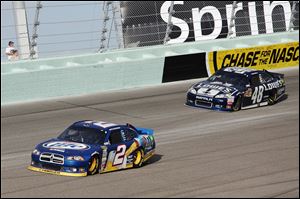 Brad Keselowski, left, and Jimmie Johnson compete during the NASCAR Sprint Cup Series race Sunday in Homestead in Homestead, Fla. Keselowski, 28-year-old Detroit native, won his first NASCAR championship won when Johnson pulled out of the season finale because of a parts failure.