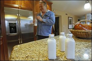 Joe Garverick drinks camel milk at his home. He says the milk is high in Vitamin C.