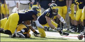 Michigan safety Jordan Kovacs chases a fumble against Iowa during the first quarter Saturday at Michigan Stadium in Ann Arbor. The Wolverines can still win their division, but they do need help: Nebraska would also need to lose.