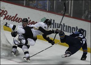 Wheeling's Cam Fergus and Peter Merth collide along with Toledo's Byron Froese during the game. The Walleye roughed up the Nailers 6-1 in an offensive display.