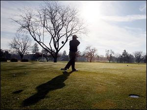 Jim White of Sylvania Township tees off on the first hole of a golf game with friends Sunday at Highland Meadows Golf Club.