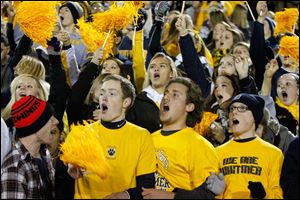Whitmer High School fans cheer their team against Massillon Washington High School during the first quarter Saturday night at Arlin Field in Mansfield.