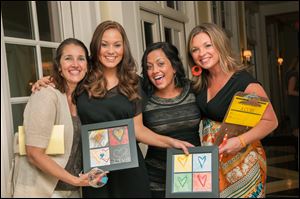 Sal's Pals wine tasting volunteers, from left, Vicky Maloy, Felicia Jiannuzzi, Nikki Bazzoli, event chairman, and Erin Dzierwa show the children's art work they  purchased.