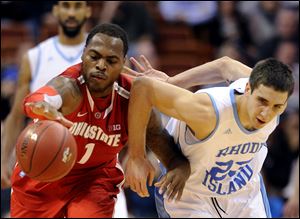 Ohio State's Deshaun Thomas, left, and Rhode Island's Nikola Malesevic fight for the loose ball. 