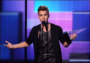 Justin Bieber accepts the award for favorite male artist in pop/rock at the 40th Annual American Music Awards on Sunday in Los Angeles.
