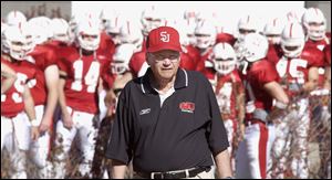 St. John's University football coach John Gagliardi leads his team onto the field at Collegville, Minn., in October, 2003.