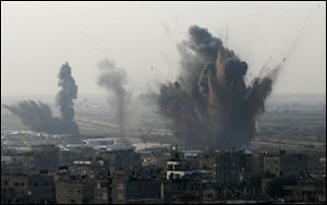 Smoke rises following an Israeli attack on smuggling tunnels on the border between Egypt and Rafah, southern Gaza Strip, Monday.