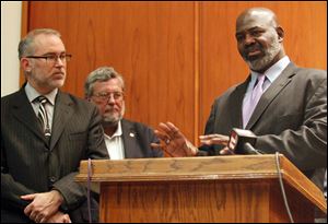 Accompanied by Finance Director Patrick McLean, left, and Deputy Mayor Steve Herwat, Toledo Mayor Mike Bell outlines his 2013 proposed budget.