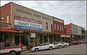 Storefronts along the main commercial street in Plains announce that the town is the home of Jimmy Carter.