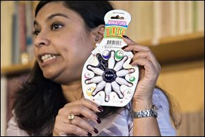 Nasima Hossain, a U.S. Public Interest Research Group spokesman, talks Tuesday about a miniature bowling set that the organization cited as posing a choking hazard.