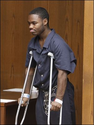 Traquawn Gibson walks in for his arraignment Tuesday in Toledo Municipal Court on a murder charge for allegedly shooting to death his girlfriend CreJonnia Bell.
