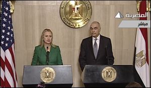 In this image made from Egyptian State Television, Secretary of State Hillary Clinton, left, and Egyptian Foreign Minister Mohammed Kamel Amr, right, give a joint news conference announcing a cease-fire between Israel and Hamas in Cairo.