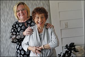 Melanie Woodby joins her mother, Lilly Yourist, 85, at Mrs.  Yourist’s Sylvania Township home. Both have survived non-Hodgkin’s lymphoma. Mrs. Yourist also experienced organ failure and underwent heart surgery.