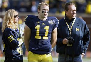Michigan safety Jordan Kovacs with his parents, Susan and Louis,  is a Clay graduate. He ranks 13th on the career tackles list at UM.