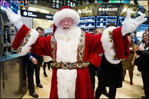Santa Claus visits the trading floor of the New York Stock Exchange this morning before he participated in opening bell ceremonies featuring the Macy's Thanksgiving Day Parade.