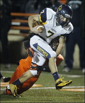 Whitmer quarterback Nick Holley breaks a tackle against Massillon Washington. He has rushed for 1,734 yards and passed for 1,587 yards in leading the Panthers to the Division I state semifinals.