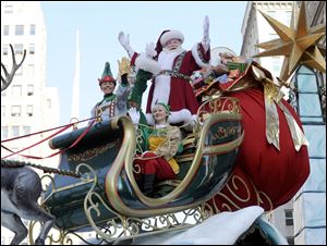 Santa Claus waves to the crowd at Herald Square during the 86th annual Macy's Thanksgiving Day Parade on Thursday.