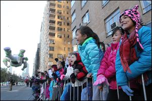 Spectators cheers during the 86th Annual Macy's Thanksgiving Day Parade on Thursday.