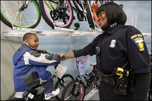Officer Katrina Welch-Bills helped Javarious Allen find a bicycle while participating in the first 