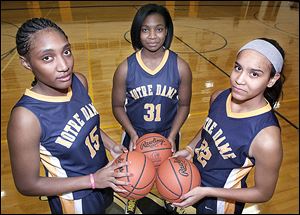 Notre Dame girls basketball players  Kaayla McIntyre, left, Tierra Floyd, center, and Jayda Worthy, right.