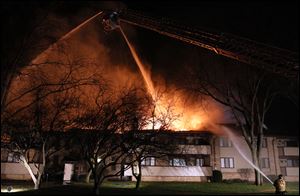 Firefighters work to put out flames at a condominium complex Thursday, on Byrnwyck West in Monclova Township.
