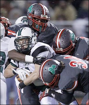 SPT CENTRAL24p  Toledo Central Catholic player Jon Perrin Jr., 50, celebrates after sacking Aurora High School quarterback George Bollas, 11, for a loss late in the fourth quarter during their Division II state semi-final game at Huron High School, Friday, November 23, 2012.  The Blade/Andy Morrison