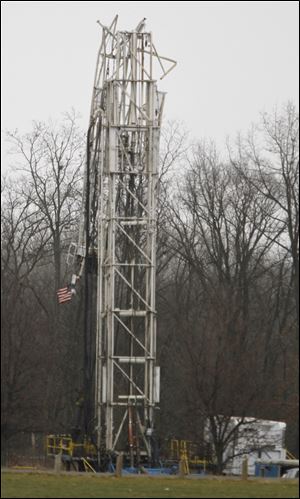 An oil rig is partially collapsed in half at Heritage Park in Adrian, Mich. The American flag was on top of the rig but is now flying upside down.
