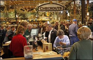 Shoppers wait to check out on Black Friday at Bass Pro Shops in Rossford. General manager Jarron Ritchie said about 700 people were waiting outside the outdoor megastore for the doors to open on Friday morning.