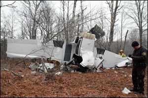 Authorities review the scene of a fatal plane crash in Mancelona, Mich., 140 miles north of Grand Rapids, Mich. Authorities found the wreckage of the Cessna 310B and the body of the pilot, Roger Crawford, 68, Friday after he missed a family gathering on Thanksgiving in Frankfort, Mich.