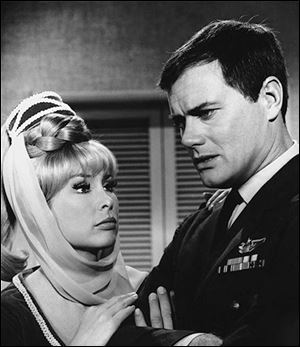 This 1967 file photo shows Barbara Eden, left, and Larry Hagman in a scene from the television show 