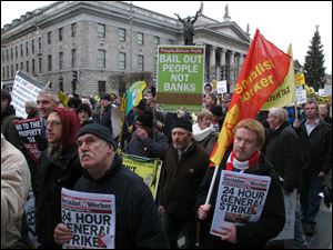Socialist protesters march past Dublin's General Post Office today in opposition to imminent spending cuts.