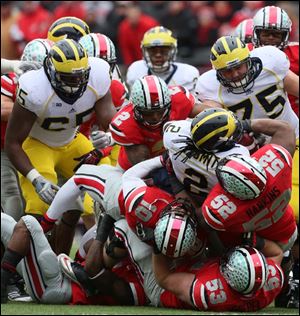 The Ohio State defense takes down Michigan's Rod Smith during the third quarter.