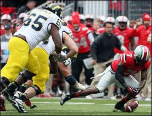 Ohio State cornerback Travis Howard recovers a fumble by Michigan's Devin Gardner in the fourth quarter.