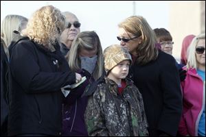 Karri Waters, left, an aunt, McKenna Shaffer, center left, a cousin, Mason Shaffer, center right, and Kristy Shaffer, right, join the ceremony to remember Andrew, Alexander, and Tanner Skelton. They were at Morenci's Wakefield Park on Sunday.