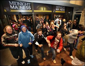Black Friday shoppers pour into the Valley River Center mall for the Midnight Madness sale, in Eugene, Ore. All told, a record 247 million shoppers visited stores and Web sites over the four-day weekend starting Thanksgiving, up 9.2 percent of last year, according to a survey of 4,000 shoppers that was conducted by research firm BIGinsight for the trade group.