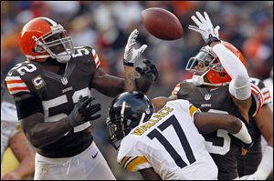 Cleveland Browns linebacker D'Qwell Jackson, left, and cornerback Joe Haden, right, break up a pass to Pittsburgh Steelers wide receiver Mike Wallace in the fourth quarter Sunday in Cleveland. The tipped ball was recovered by Browns defensive tackle Billy Winn. The Browns won 20-14.