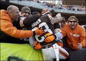 Cleveland Browns cornerback Joe Haden (23) is hugged by fans after a 20-14 win over the Pittsburgh Steelers in an NFL football game today.