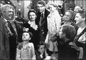 James Stewart, center, is reunited with his wife, Donna Reed, left, and children during the last scene of Frank Capra's 1946 classic, ‘It's A Wonderful Life.' 