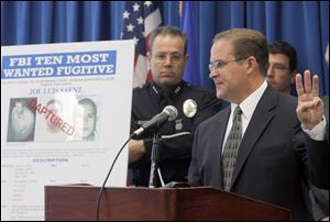 Bill Lewis, the FBI Los Angeles Assistant Director in Charge, right, and Los Angeles Police Assistant Chief Michael Moore, left, today announces the arrest of suspect Joe Luis Saenz, one of the FBI Ten Most Wanted fugitives, Thursday.