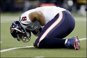 Houston Texans quarterback Matt Schaub (8) picks himself up after a hit by Detroit Lions defensive tackle Ndamukong Suh during the first quarter of an NFL football game at Ford Field in Detroit, Thursday, Nov. 22, 2012. (AP Photo/Paul Sancya)