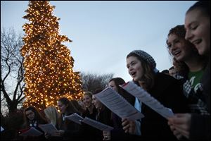The Perrysburg High School Jazz Singers perform Christmas carols during the tree lighting ceremony at Hood Park to conclude the Home for the Holidays Parade in Perrysburg.